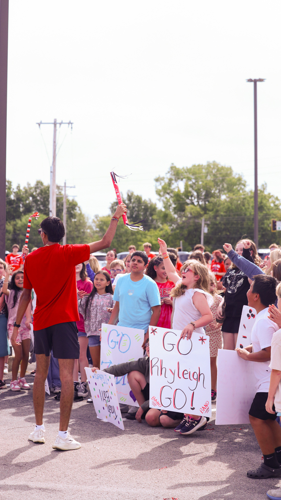 Students cheering for spirit stick