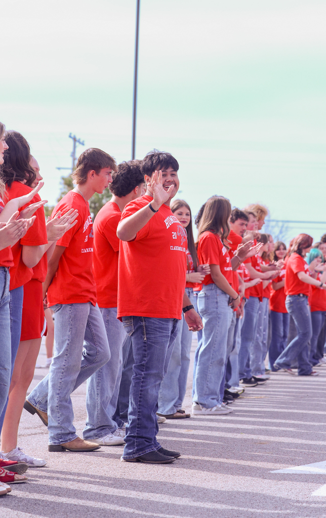 Homecoming Rep waving at students