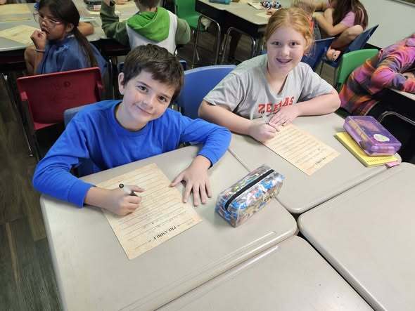 students smiling and writing the preamble