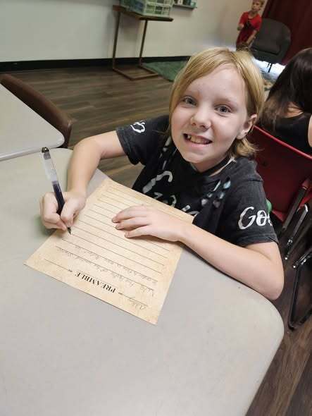 students smiling and writing the preamble