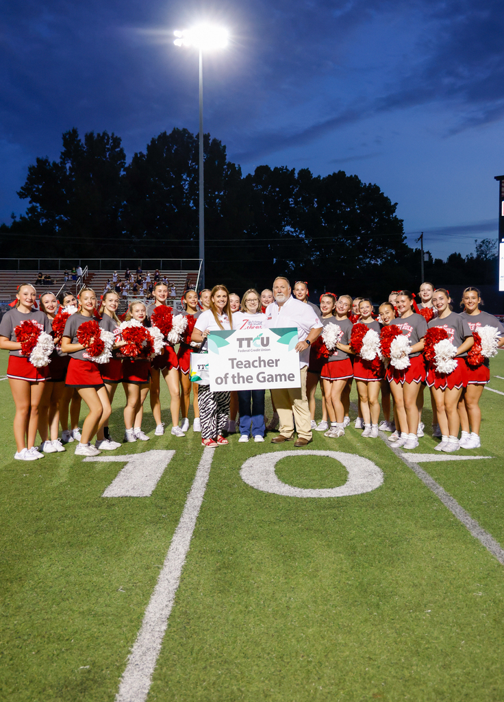 Sarah Gray with Brooke Lee, Bryan Frazier and the cheerleaders receiving teacher of the game
