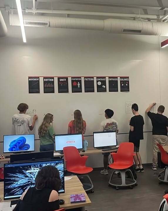 Student drawing icons on the wall 