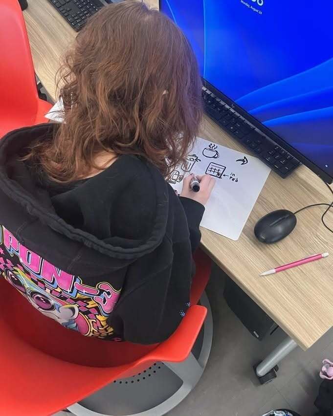 Student drawing on paper