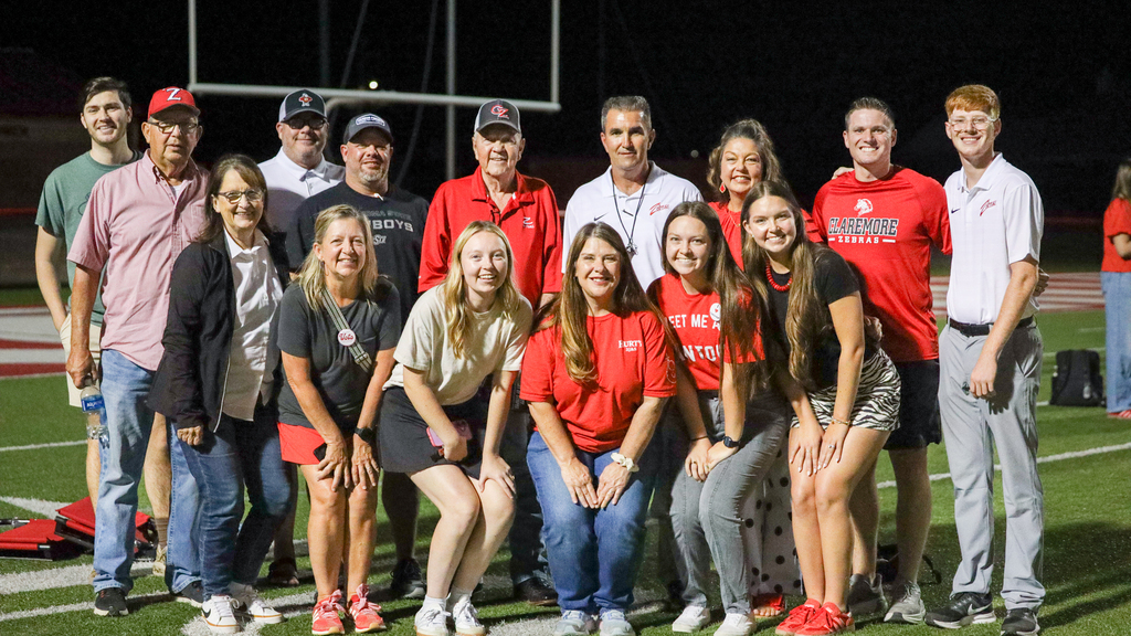 Coach Hurt celebrates his 100th career win surrounded by family, friends, and supporters.