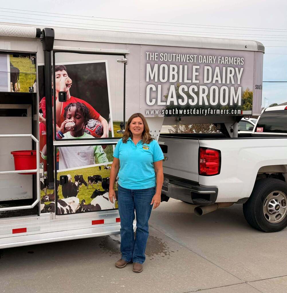 Suzie poses with the Southwest Dairy Farmers Mobile Dairy Classroom.
