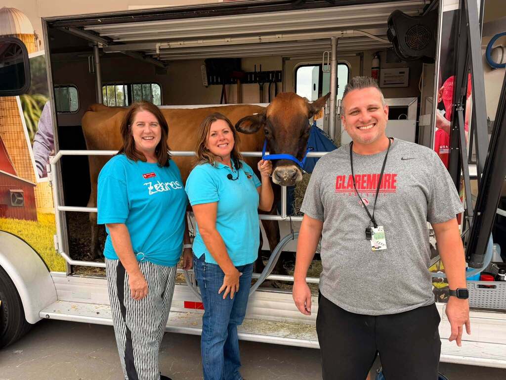 Catalayah staff pose with Cheryl the Cow and the Mobile Dairy Classroom.
