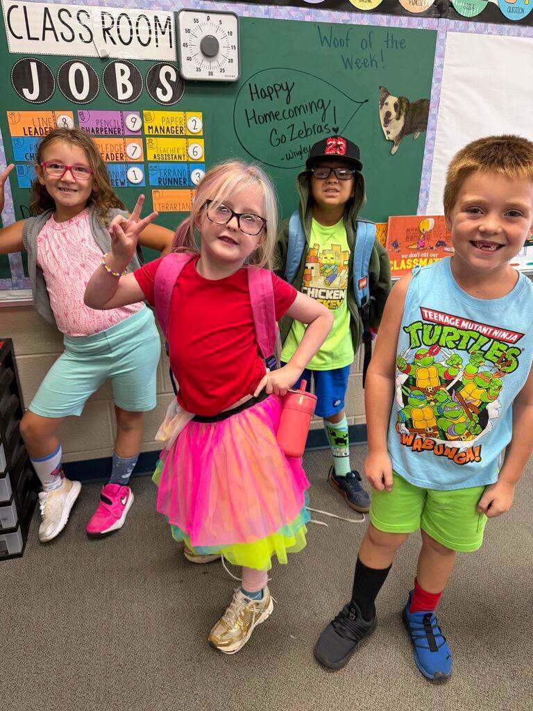 Four students dressed in colorful, mismatched outfits.