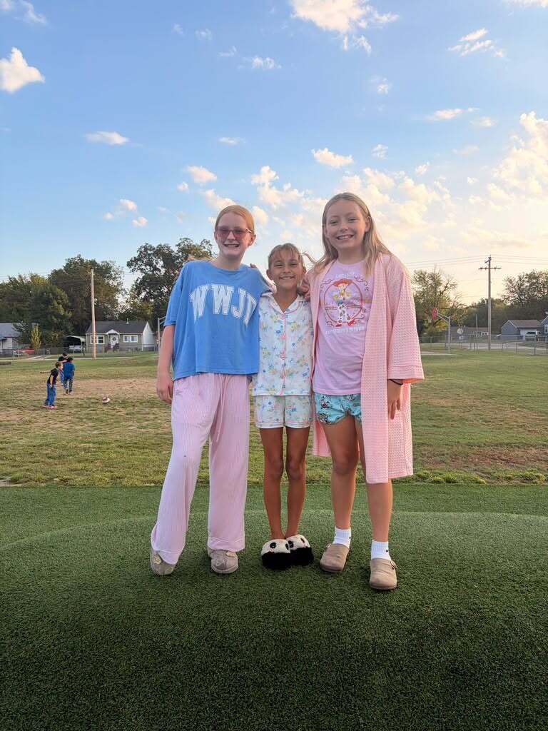 Three students dressed in pajamas for spirit day.
