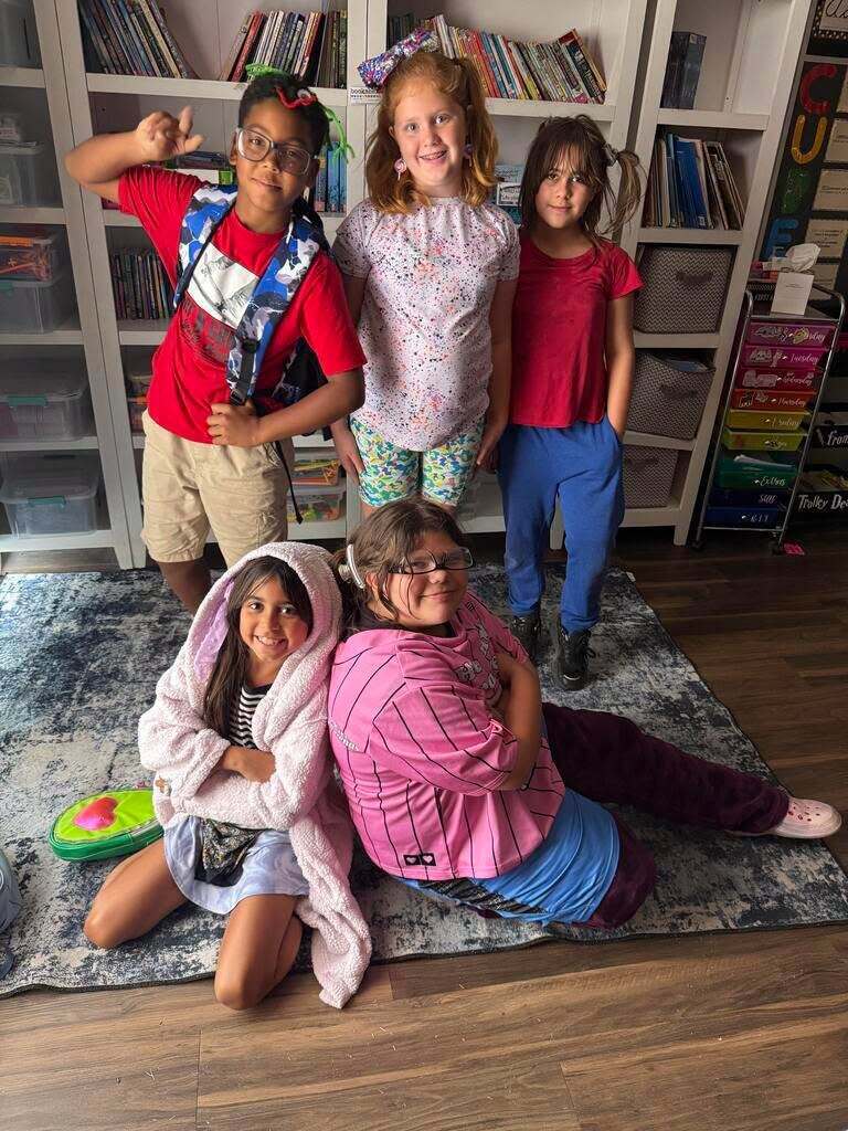 Five students posing in fun, wacky outfits.