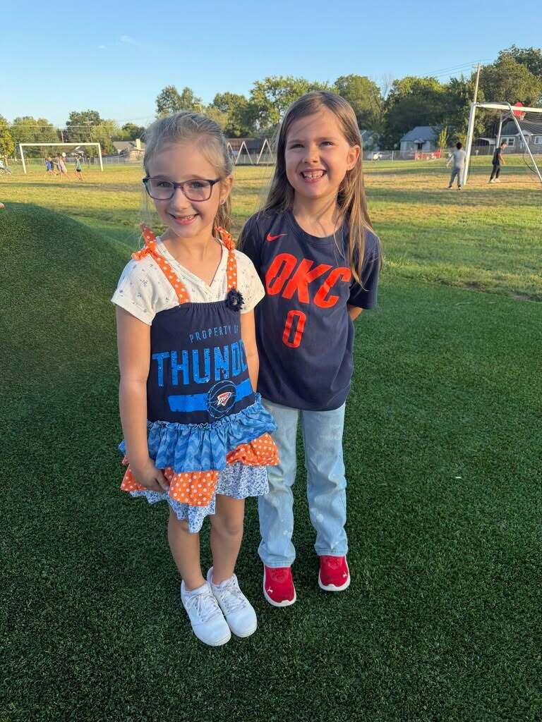 Two students wearing Oklahoma City Thunder gear.
