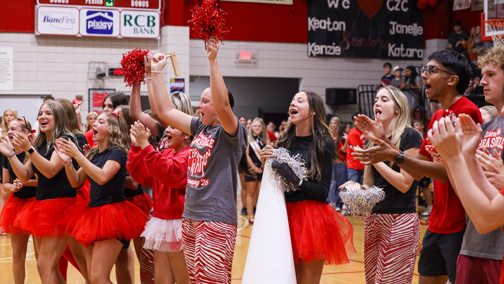 Students cheer with pom-poms during the WRJH Homecoming assembly
