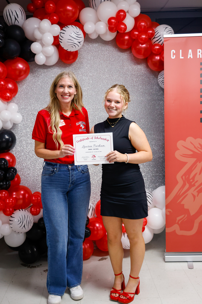 CHS senior holding a scholarship certificate with a Claremore alumna at the Homecoming Alumni Breakfast.