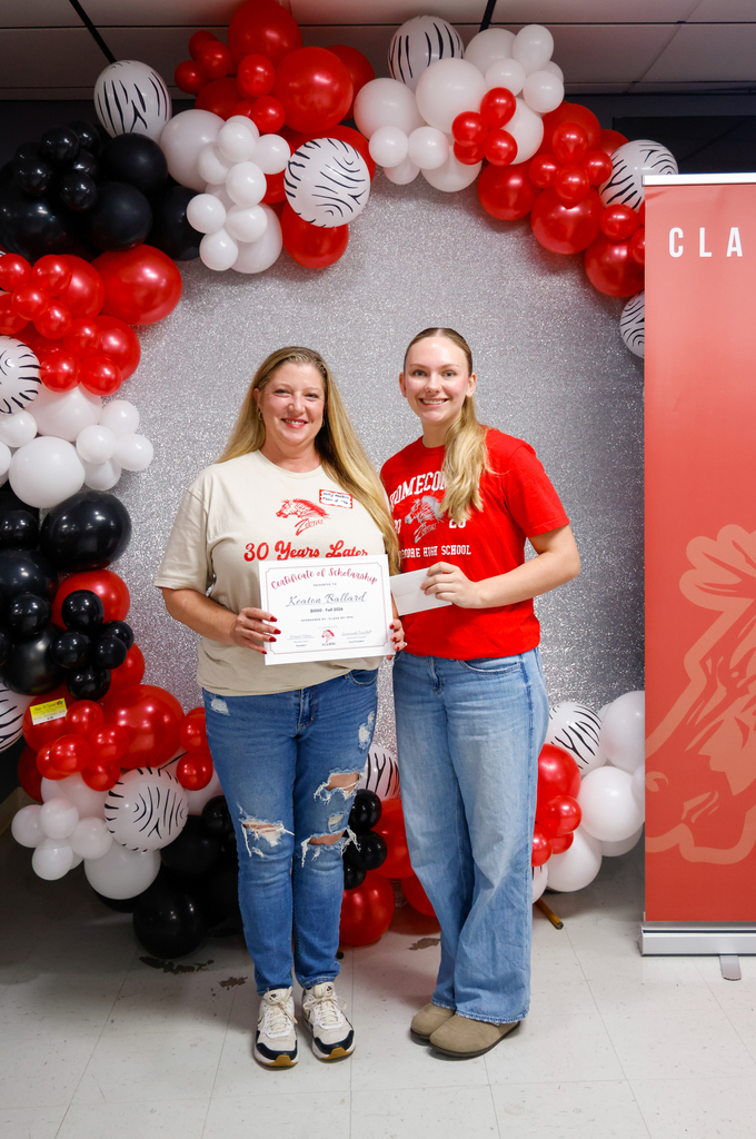 CHS senior posing with a Class of 1996 representative after receiving an Alumni Association scholarship.