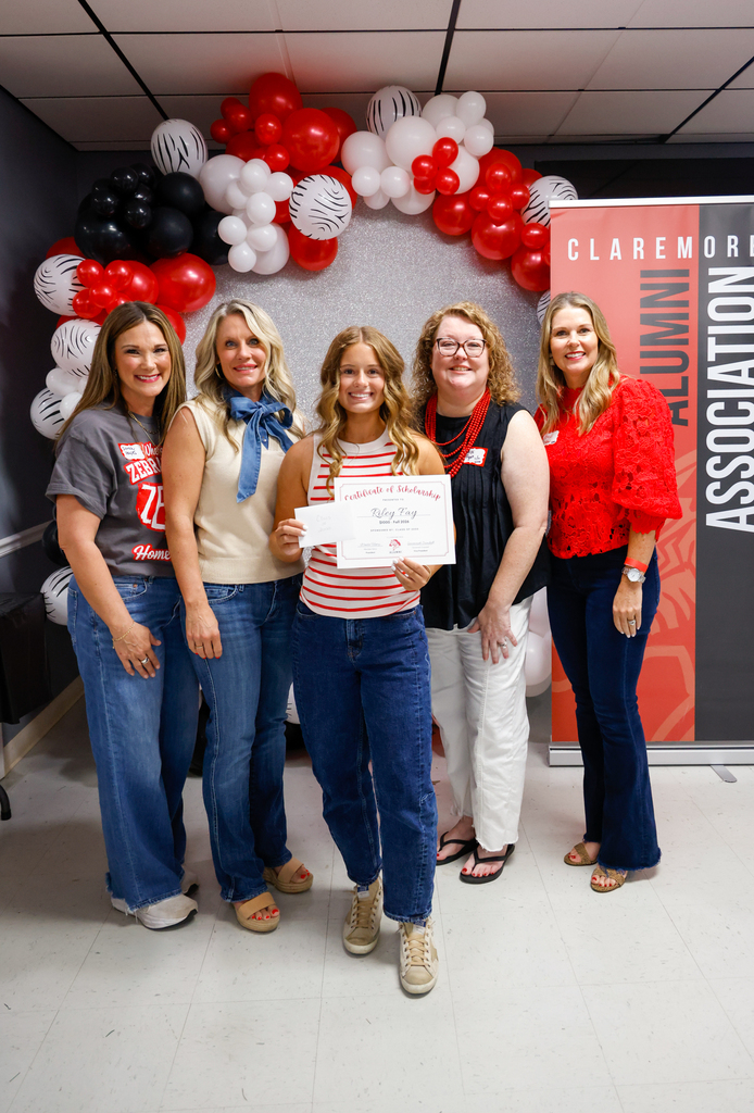 CHS senior holding a scholarship certificate with a Claremore alumna at the Homecoming Alumni Breakfast.