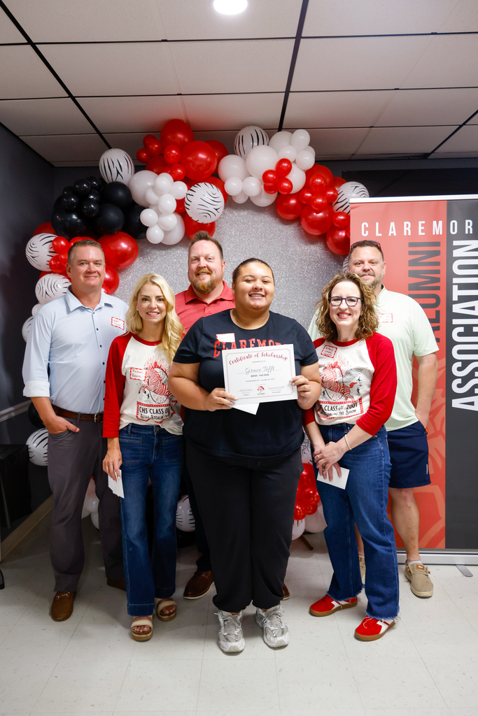 CHS senior holding a scholarship certificate with members of the Class of 2001