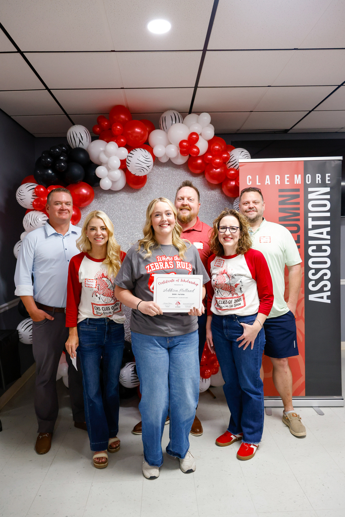 CHS senior holding a scholarship certificate with members of the Class of 2001