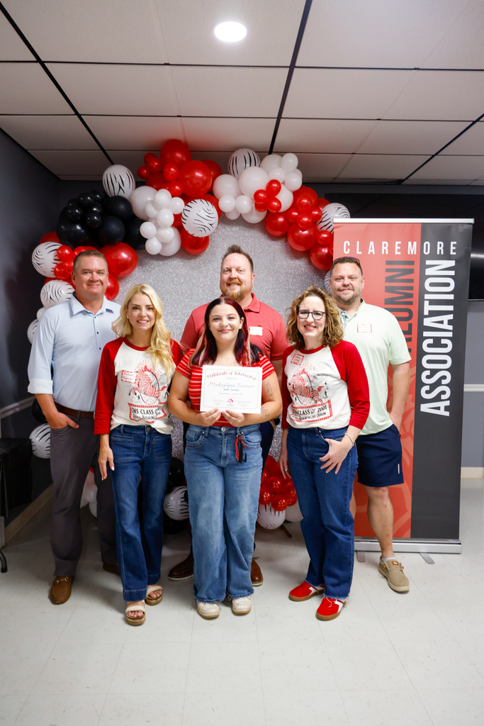 CHS senior holding a scholarship certificate with members of the Class of 2001