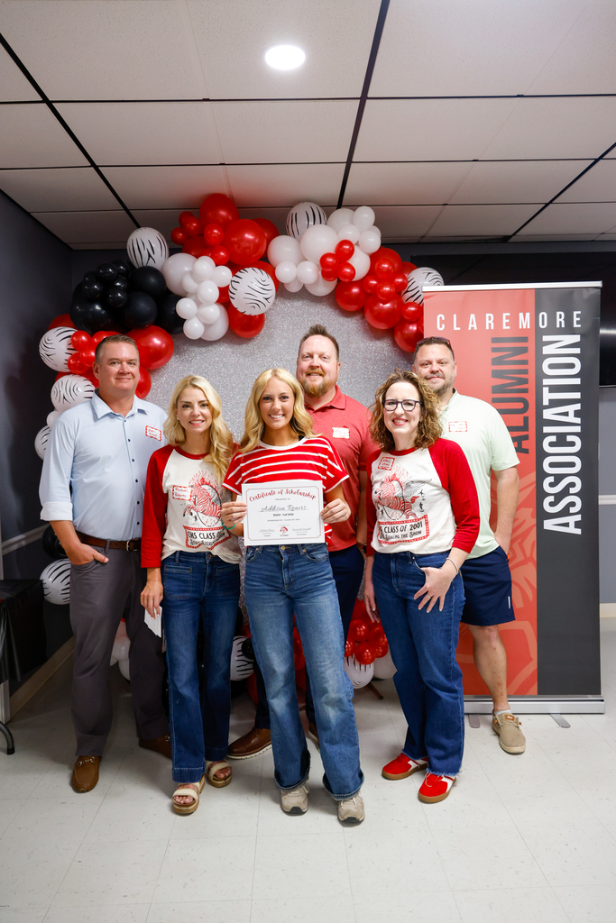 CHS senior holding a scholarship certificate with members of the Class of 2001