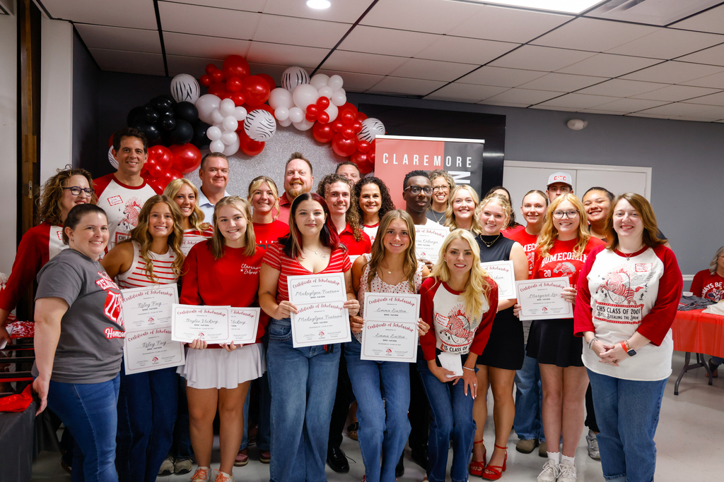 CHS senior holding a scholarship certificate with members of the Class of 2001