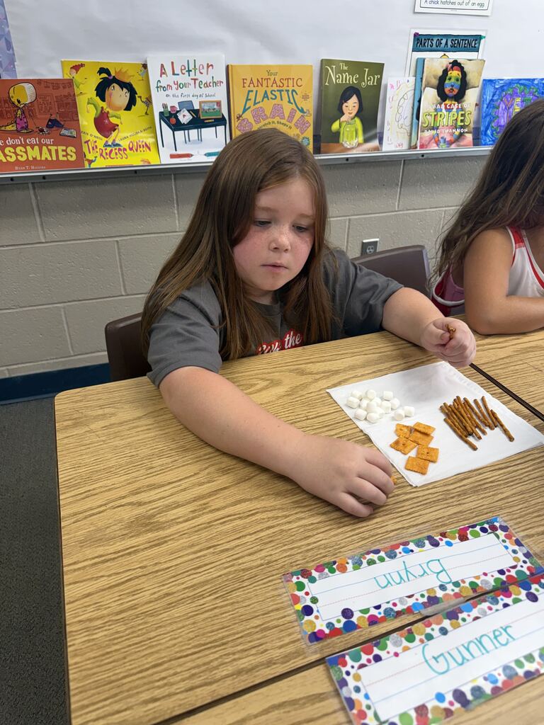 student smiling with snacks in front of her