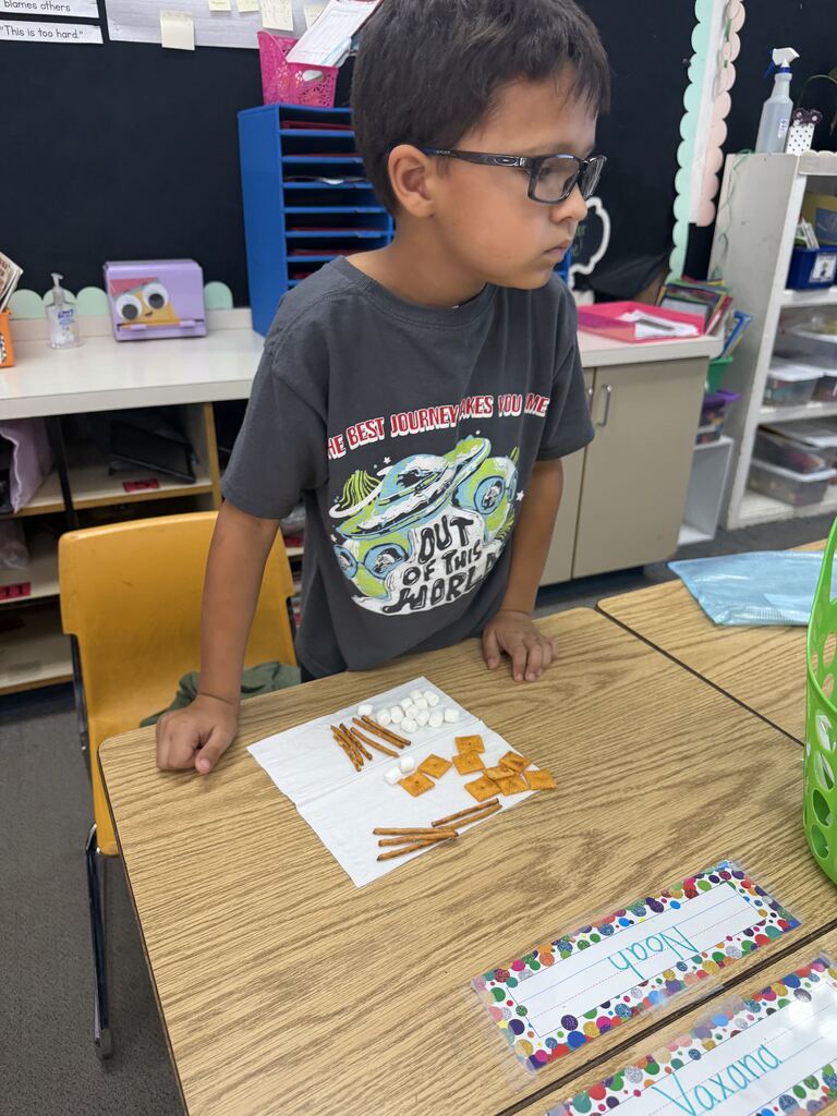 student smiling with snacks in front of him