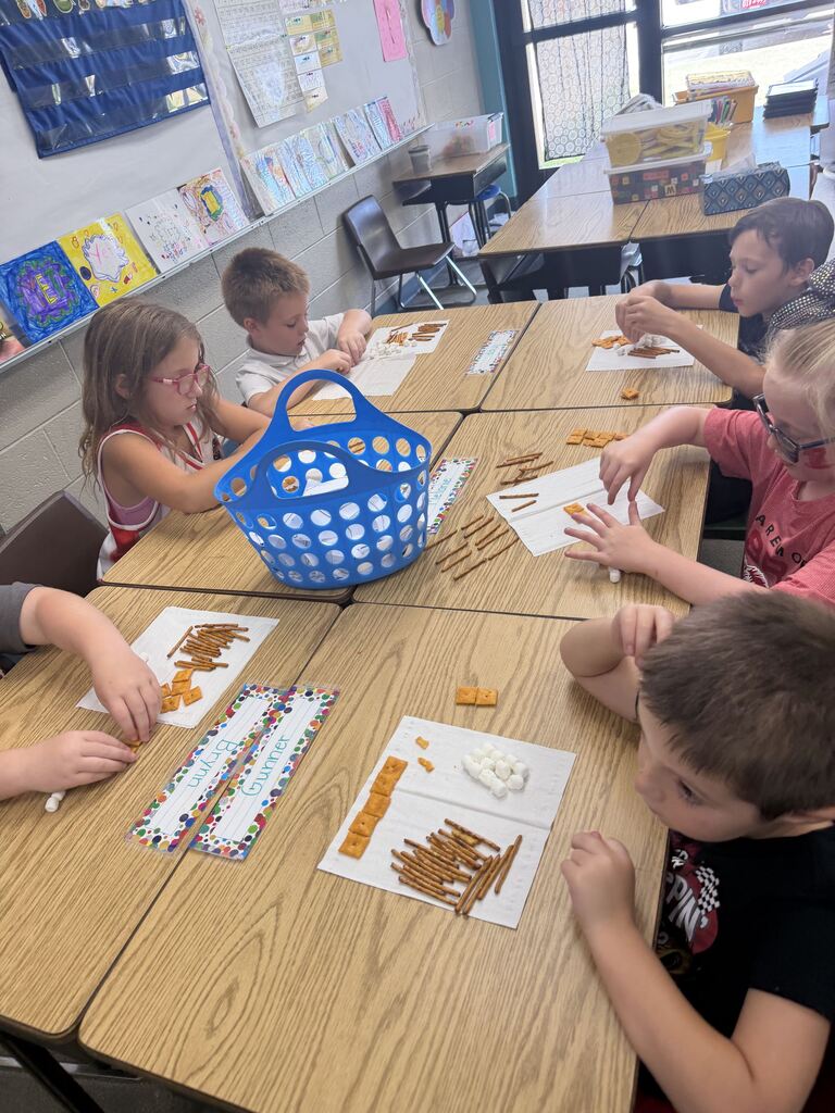 students smiling with snacks in front of her