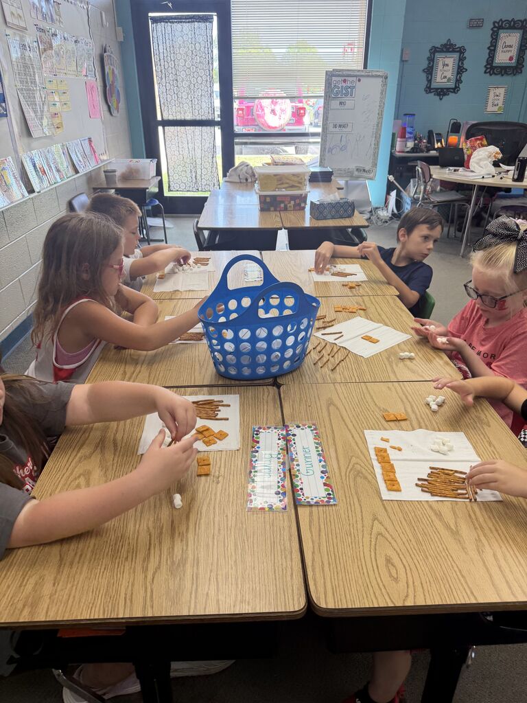 students smiling with snacks in front of her