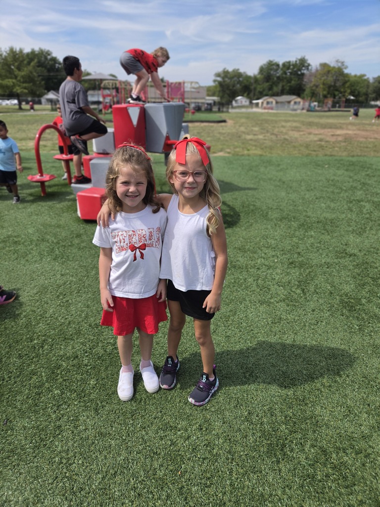 two girls standing at the playground