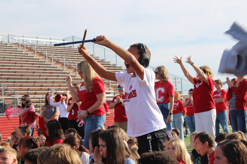 student hitting drumsticks