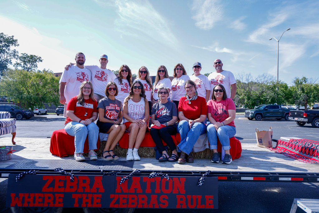 CPS Foundation members and the Teacher of the Year pose with their Homecoming float.