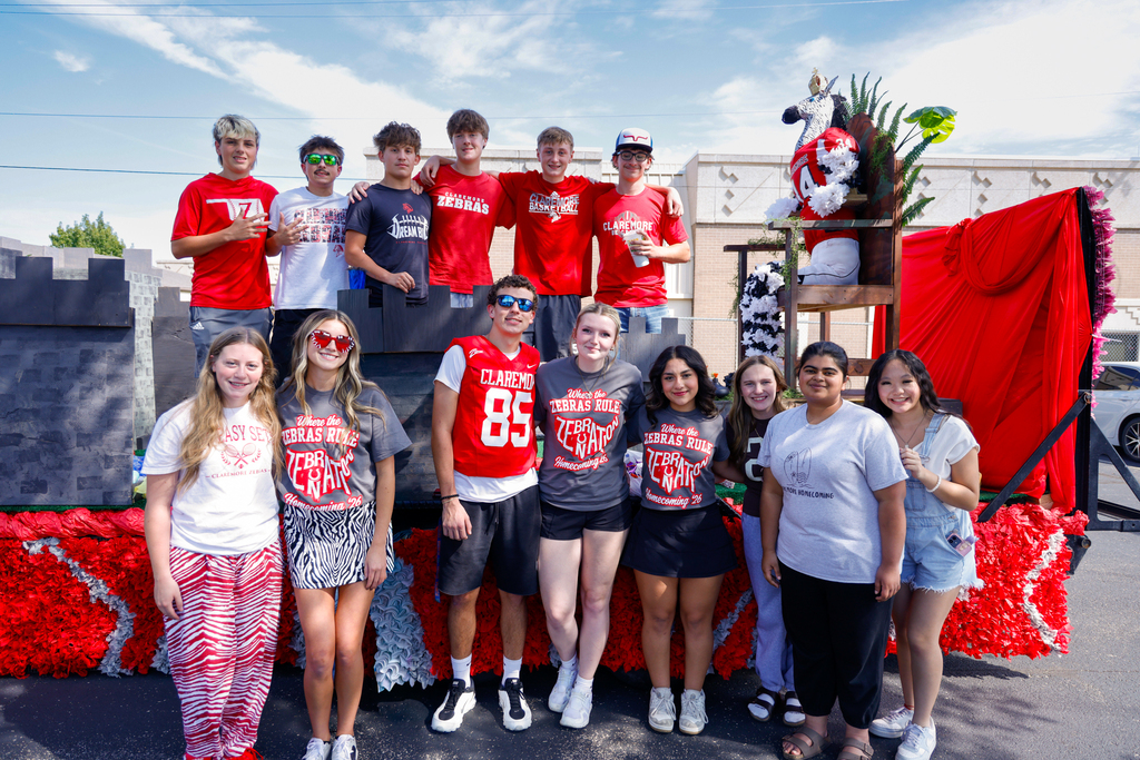 Junior class members pose with their Homecoming float.