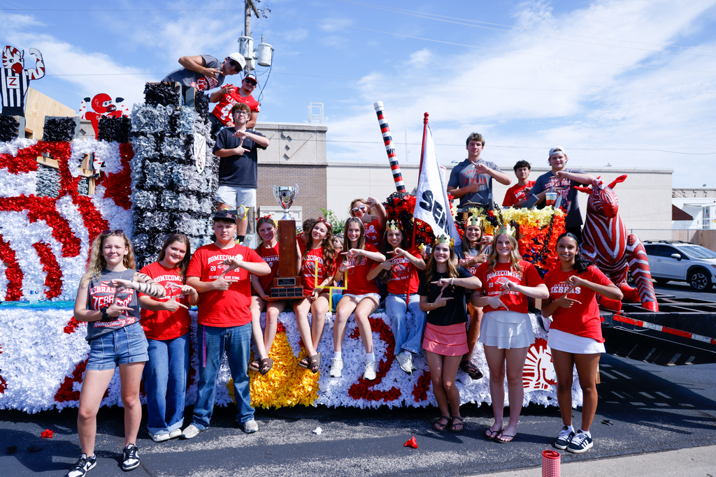 Senior class members pose with their Homecoming float.