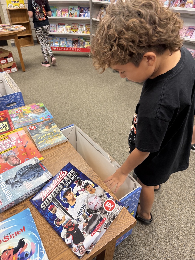 student browsing books at book fair
