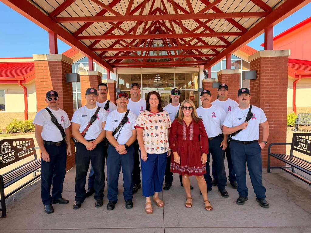 Claremore firefighters pose with two staff members outside Catalayah Elementary.