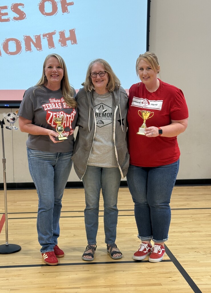 Mrs ward, ms. browning, and mrs. meeker all smiling with the outside women holding trophies