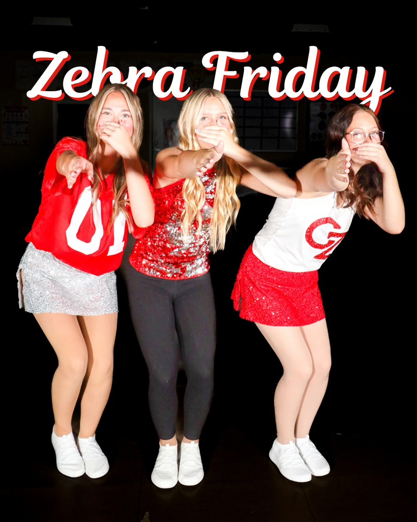 Three dancers in red and white spirit wear strike playful poses.
