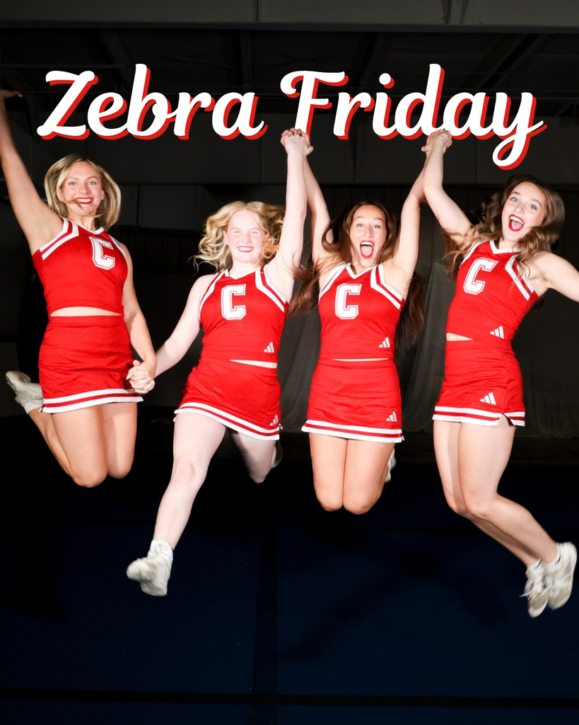 Four Zebra cheerleaders jump together in red uniforms.
