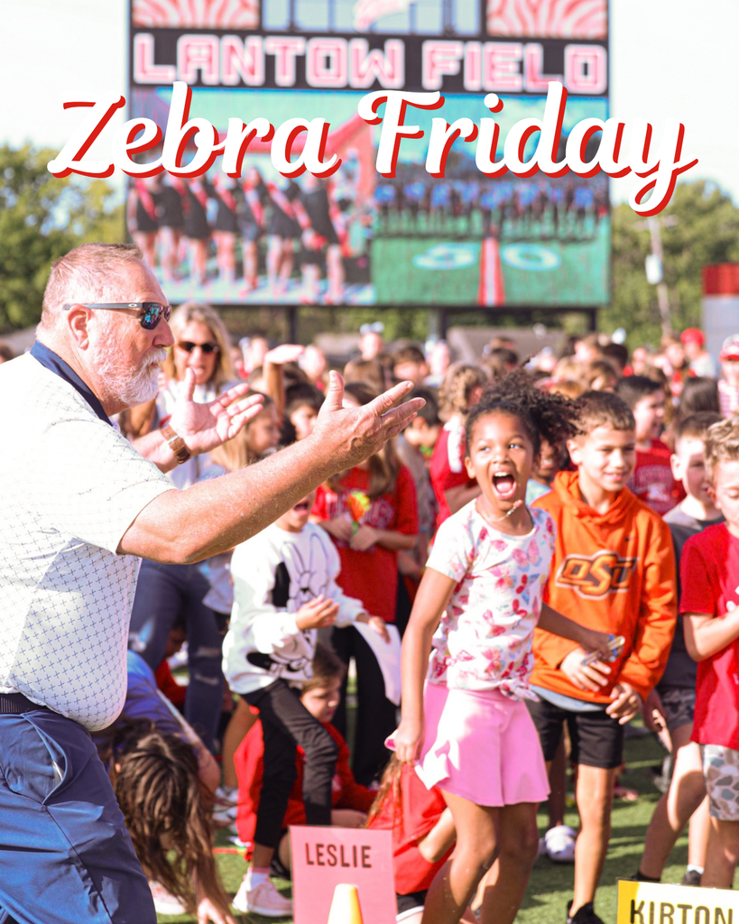 Students cheer with Bryan Frazier during a school spirit event at Lantow Field.