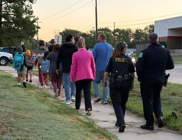 staff and community members walking to school