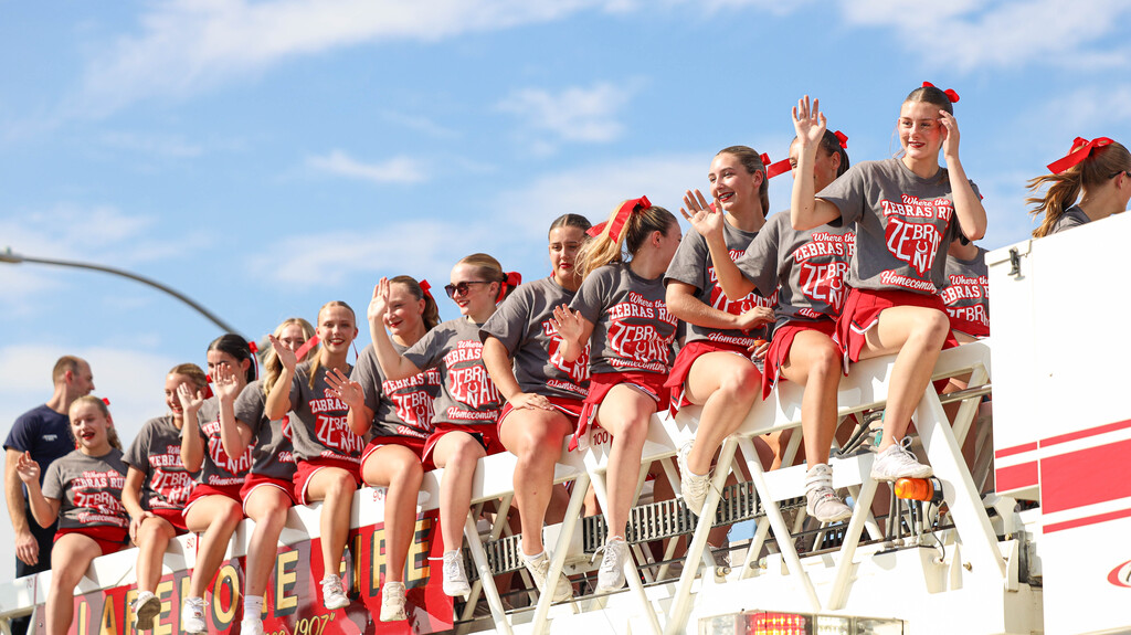 Claremore cheerleaders wave from a fire truck during the Homecoming parade.