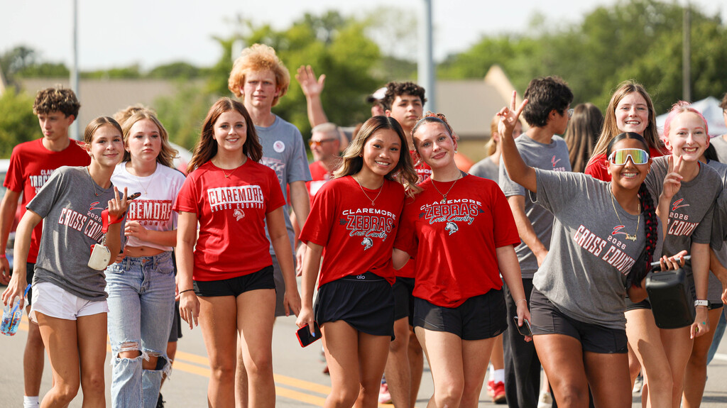 Claremore cross country runners walk together in the Homecoming parade.