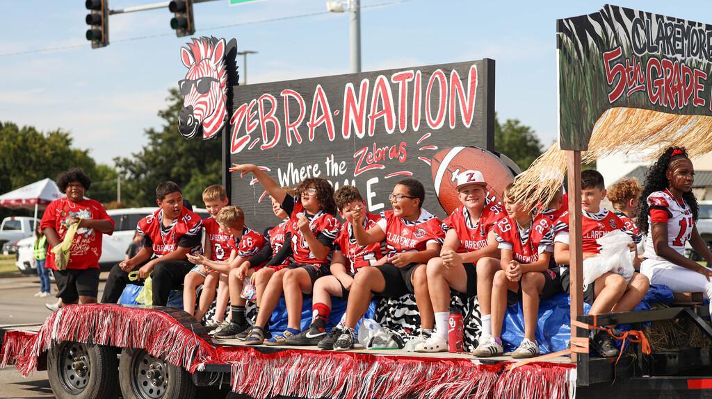 Young football players ride a Zebra Nation float in the parade.