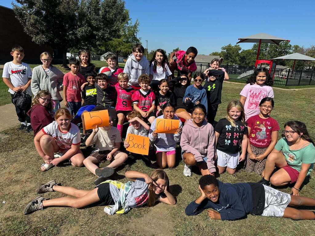 over 20 students smiling in a group for the 5 book club