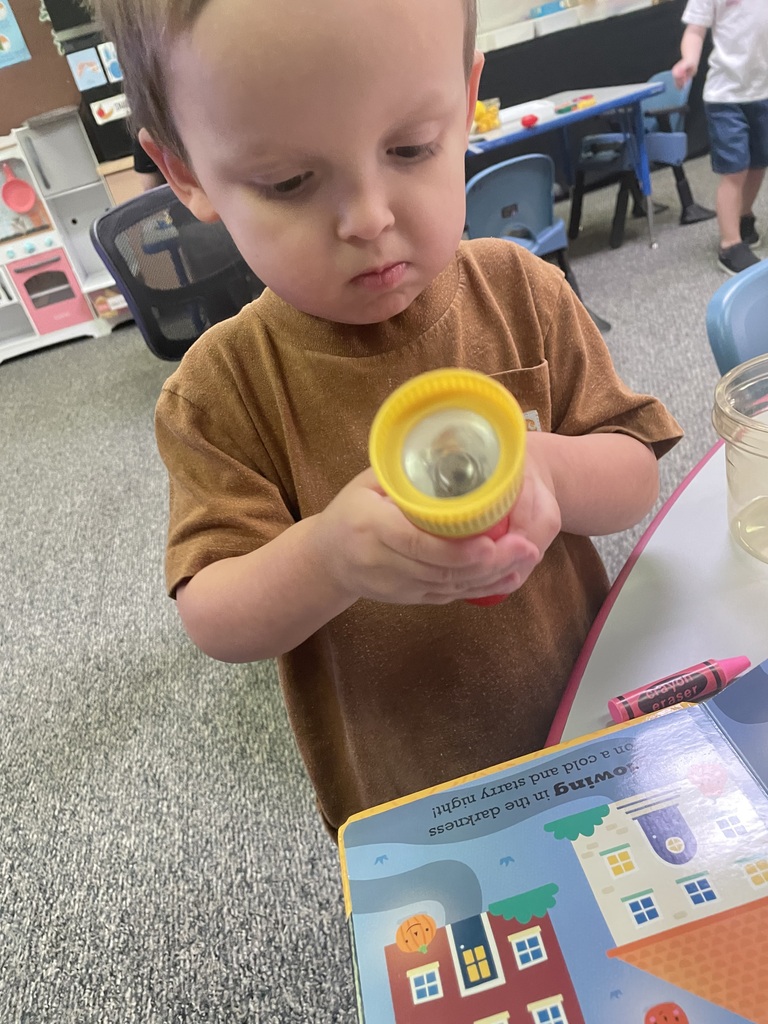 student holding flashlight