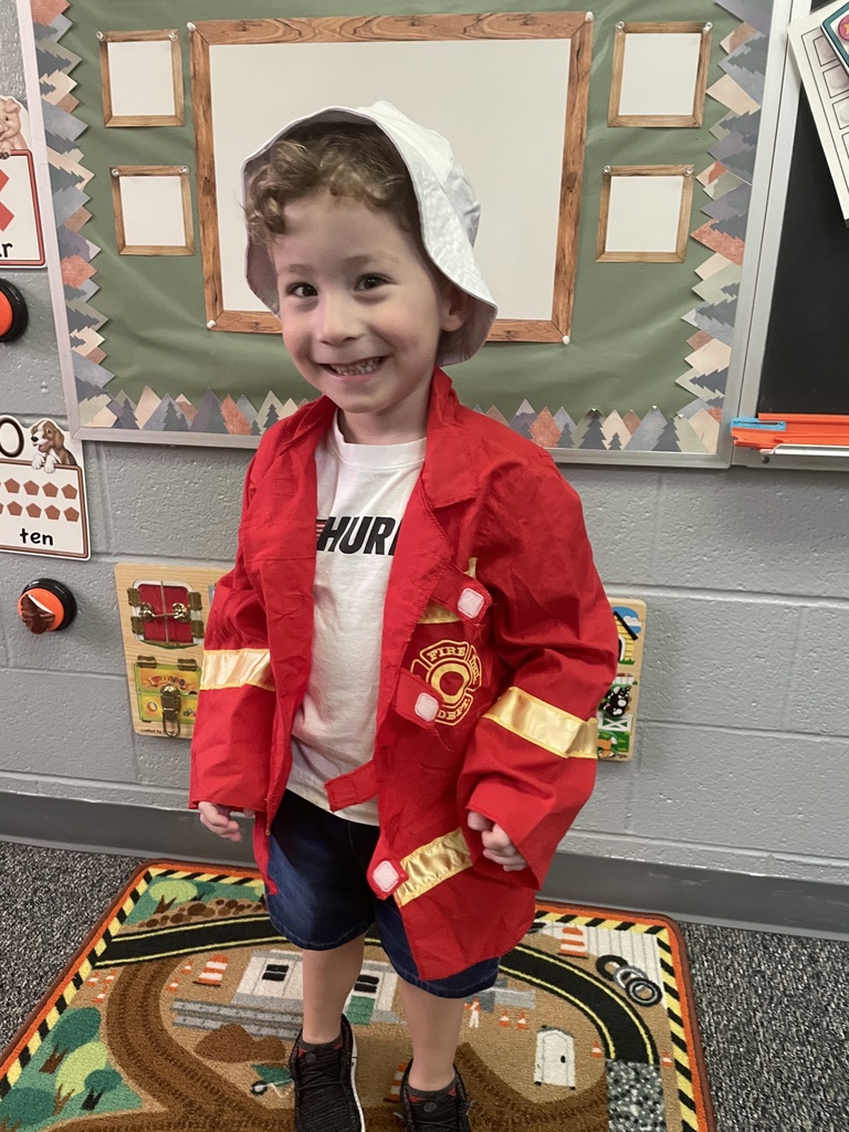 student dressed as fire fighter smiling