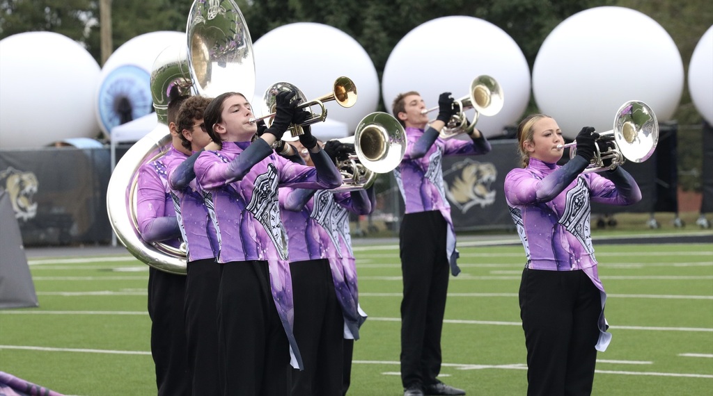 Zebra Band brass players perform in their purple competition uniforms.