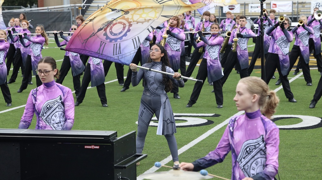 Zebra Band musicians and color guard perform their competition show on the field.