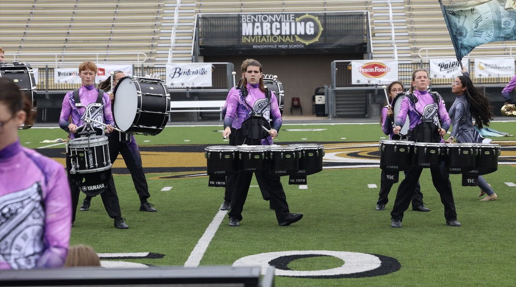 Zebra Band percussionists march and perform on the competition field.