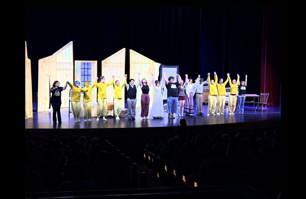 The cast of The Yellow Wallpaper takes a bow together on stage.