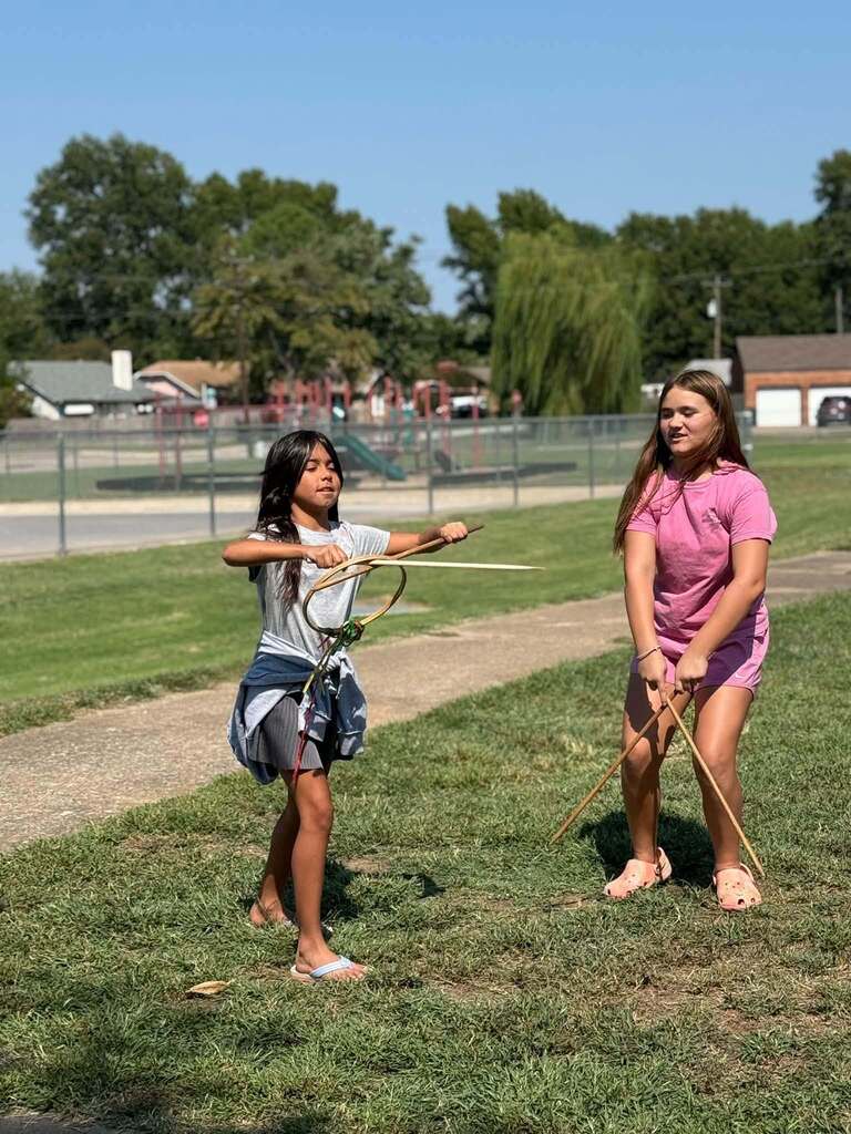 students playing with circular items outside